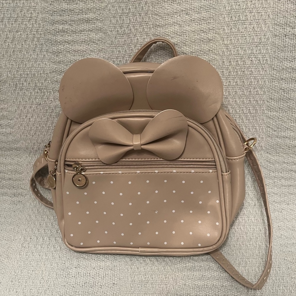 I’m selling you tan with white polkadots, small backpack